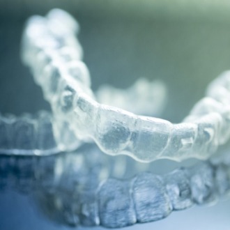 Two Invisalign clear aligners on table