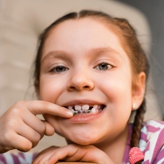 Young girl with pediatric orthodontics smiling